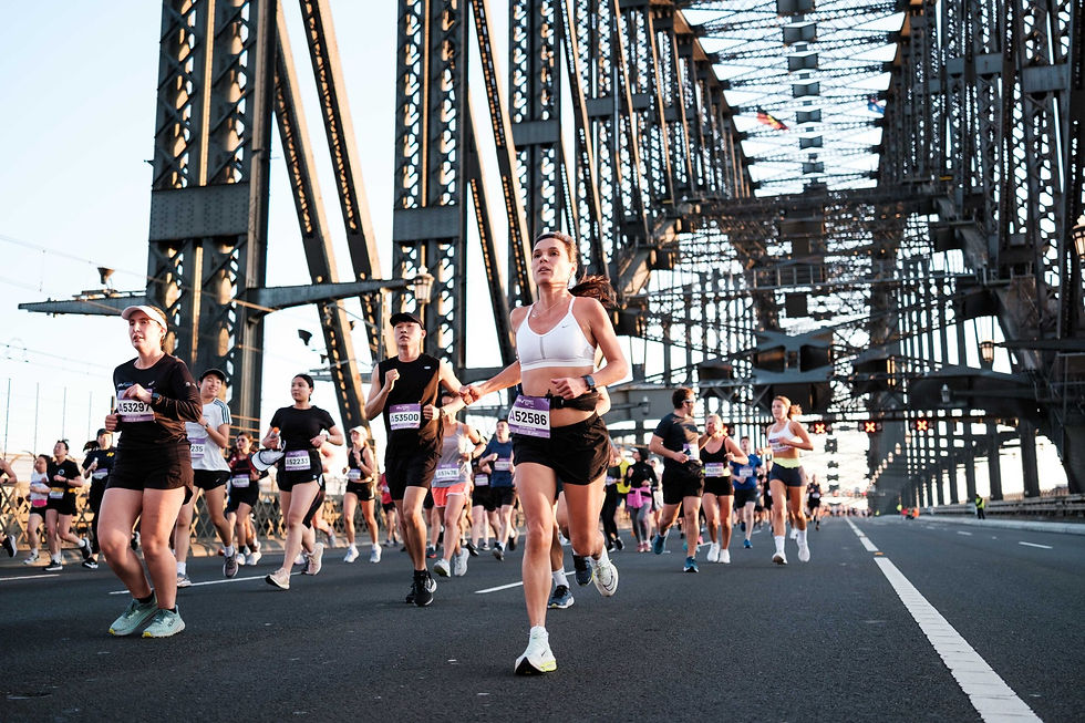 Runners crossing the Sydney Harbour Bridge during a marathon event.